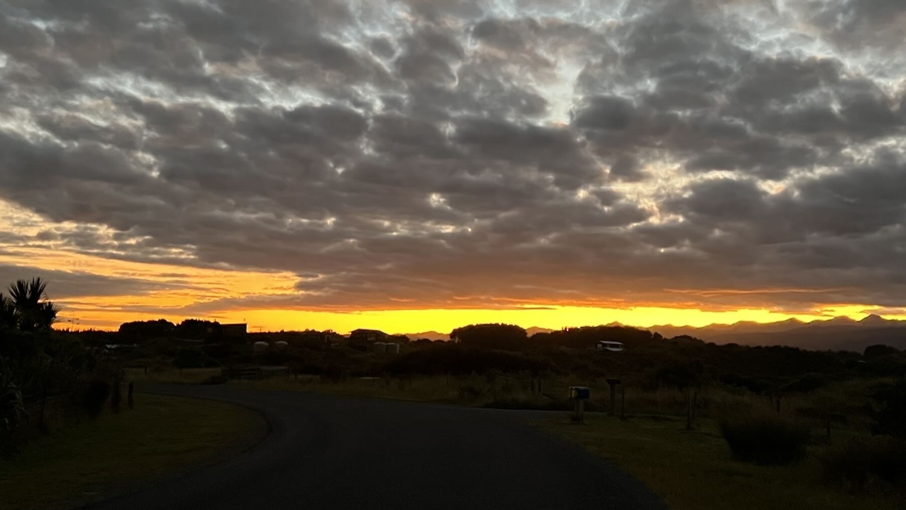 A strip of orange sky at sunrise, resembling an opening eye. 