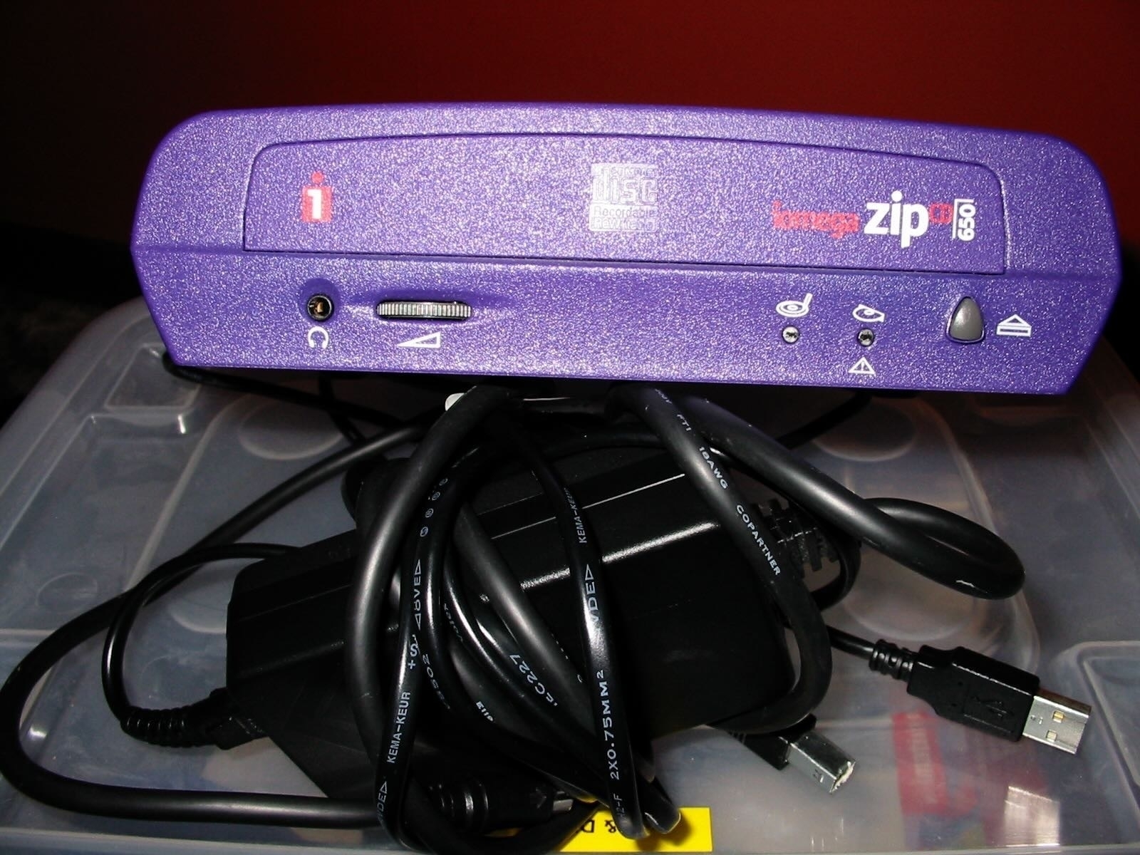 Purple plastic box on top of a power cord. 