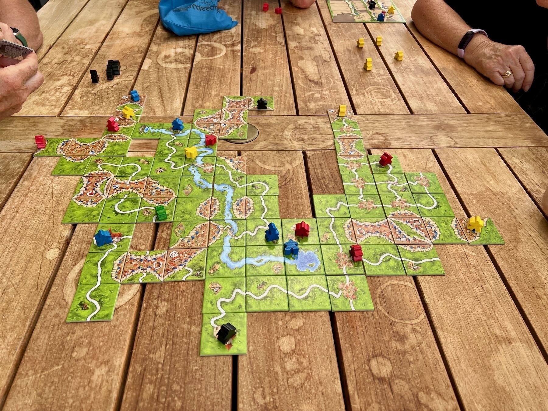 Carcassonne tiles laid out on a table. 