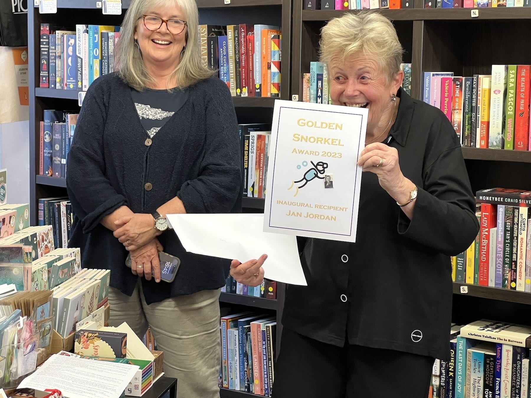 Jan Jordan holds up an award certificate created by her writing group. 