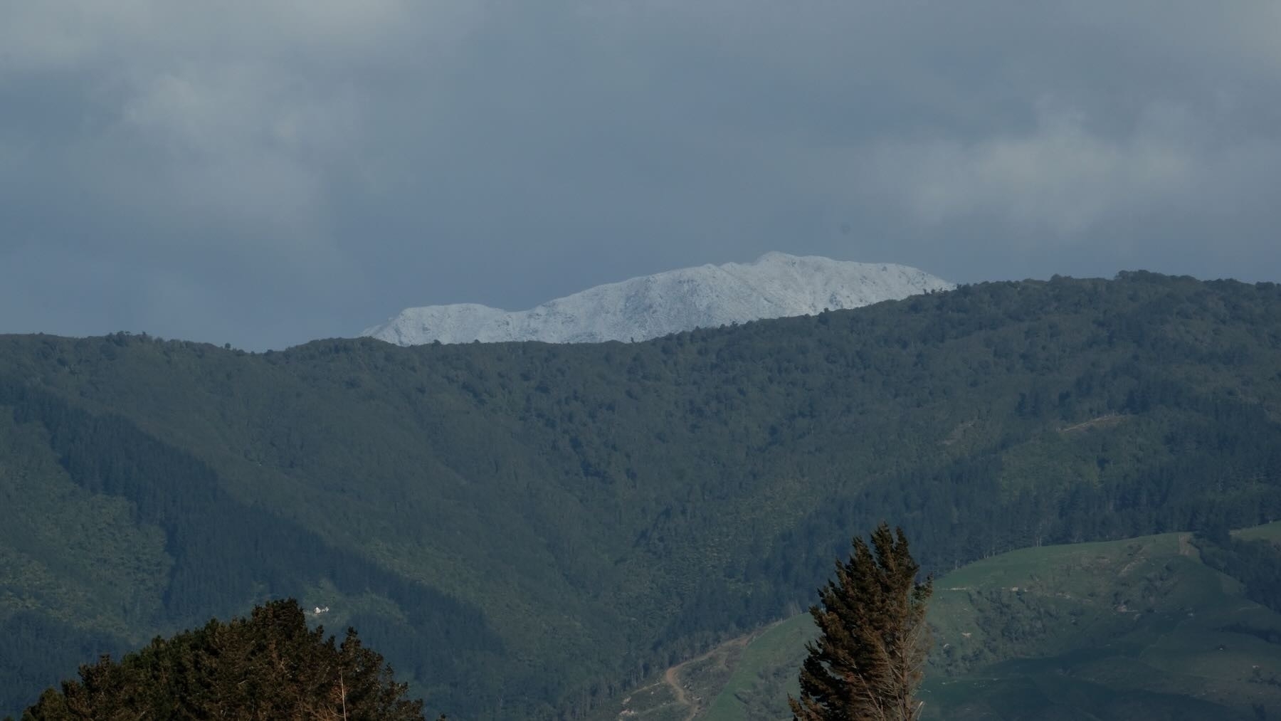 Single peak covered in snow. 