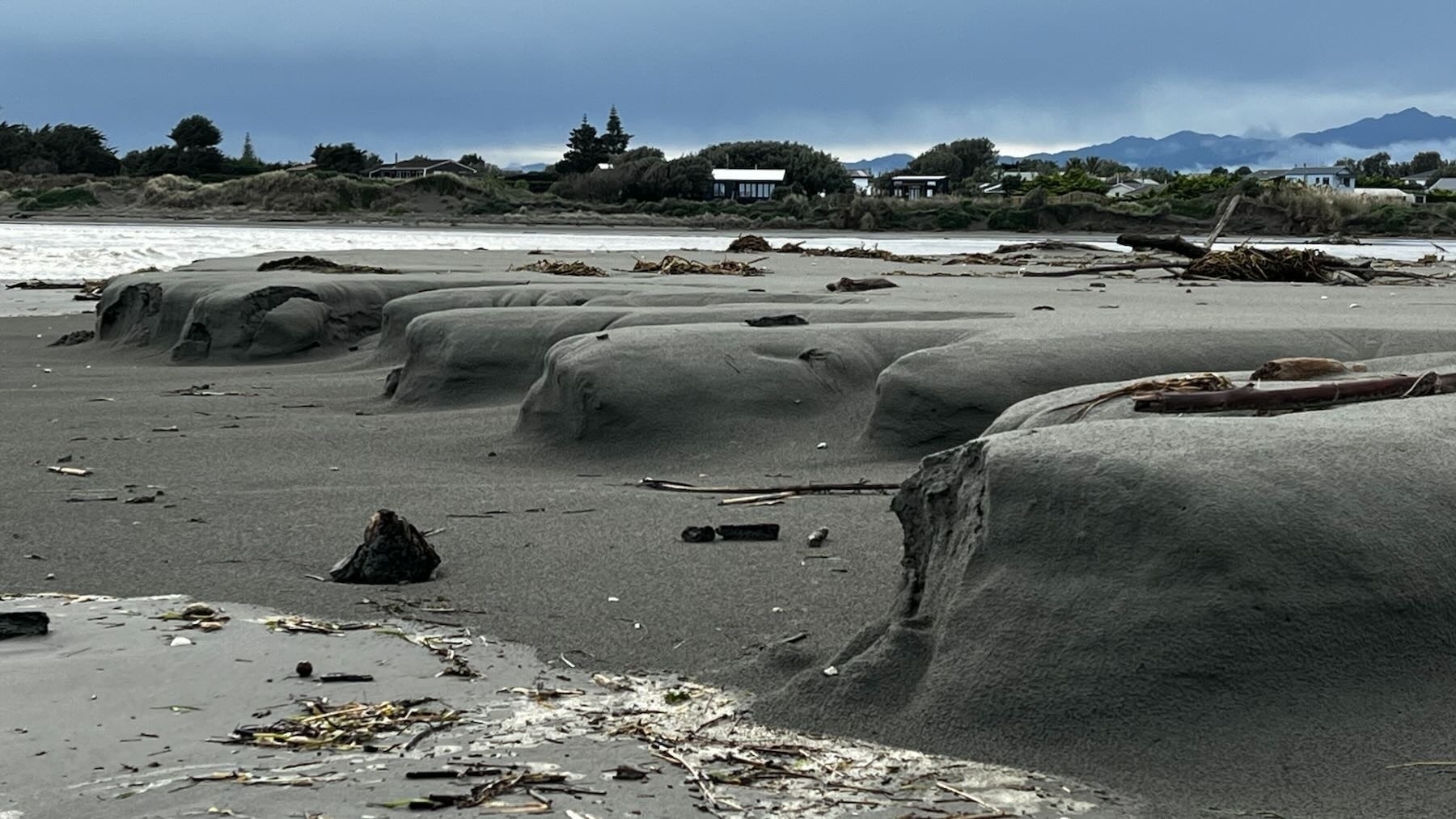 Fingers of sand at the shore. 