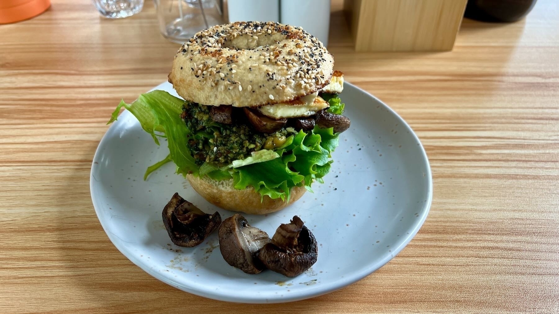 Bagel loaded with lettuce, mushroom, pesto and halloumi.