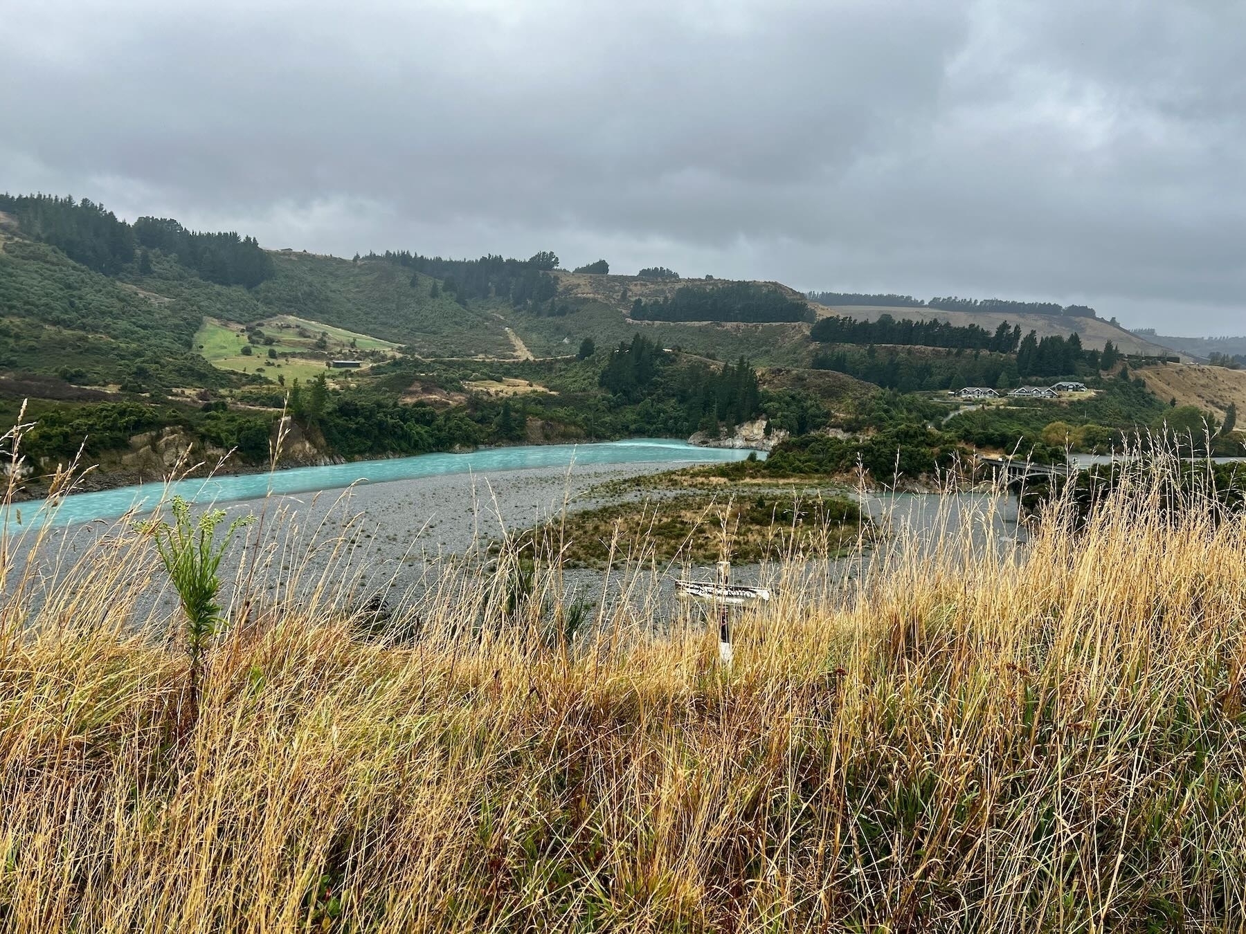 Rakaia Gorge - blue river below green hills with golden grass in the foreground.