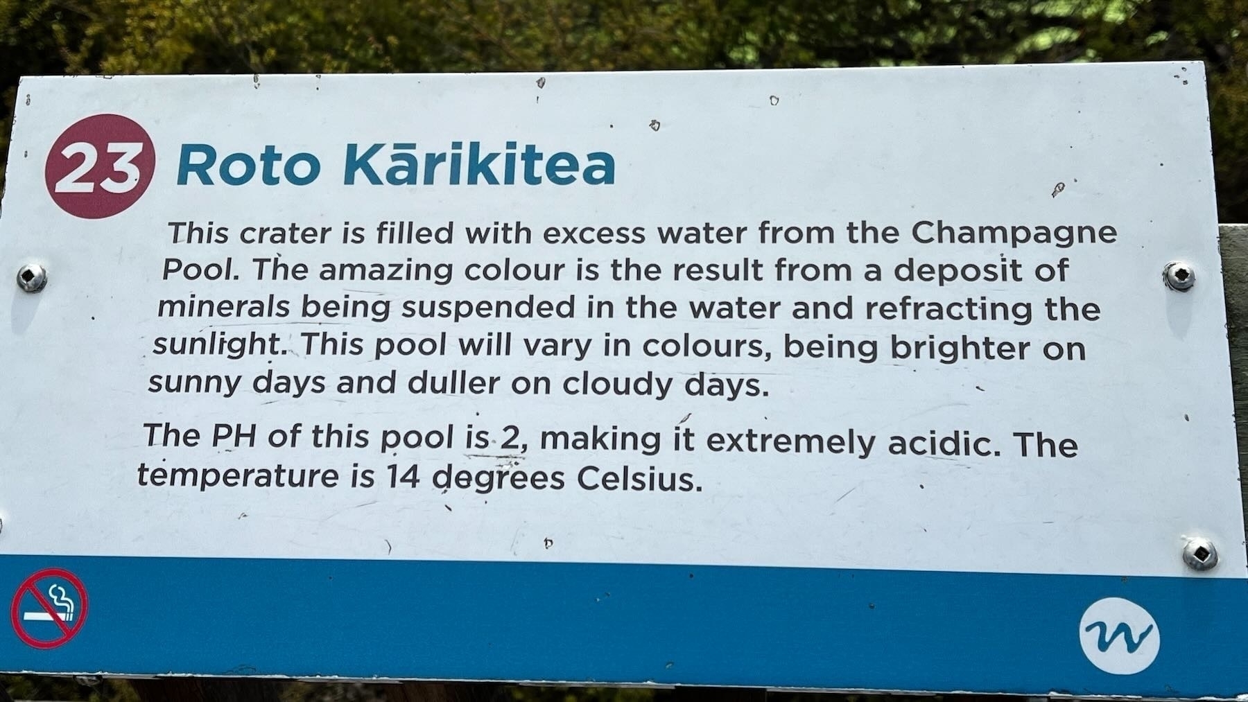 Info board explains the yellow of the lake comes from suspended minerals. 