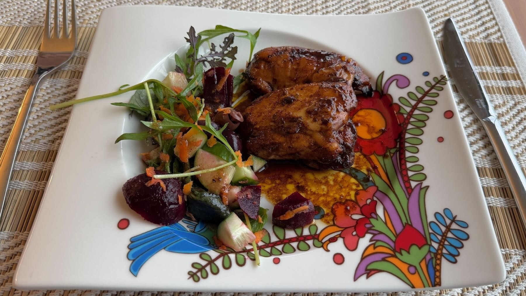 Chicken and salad on an attractive plate.