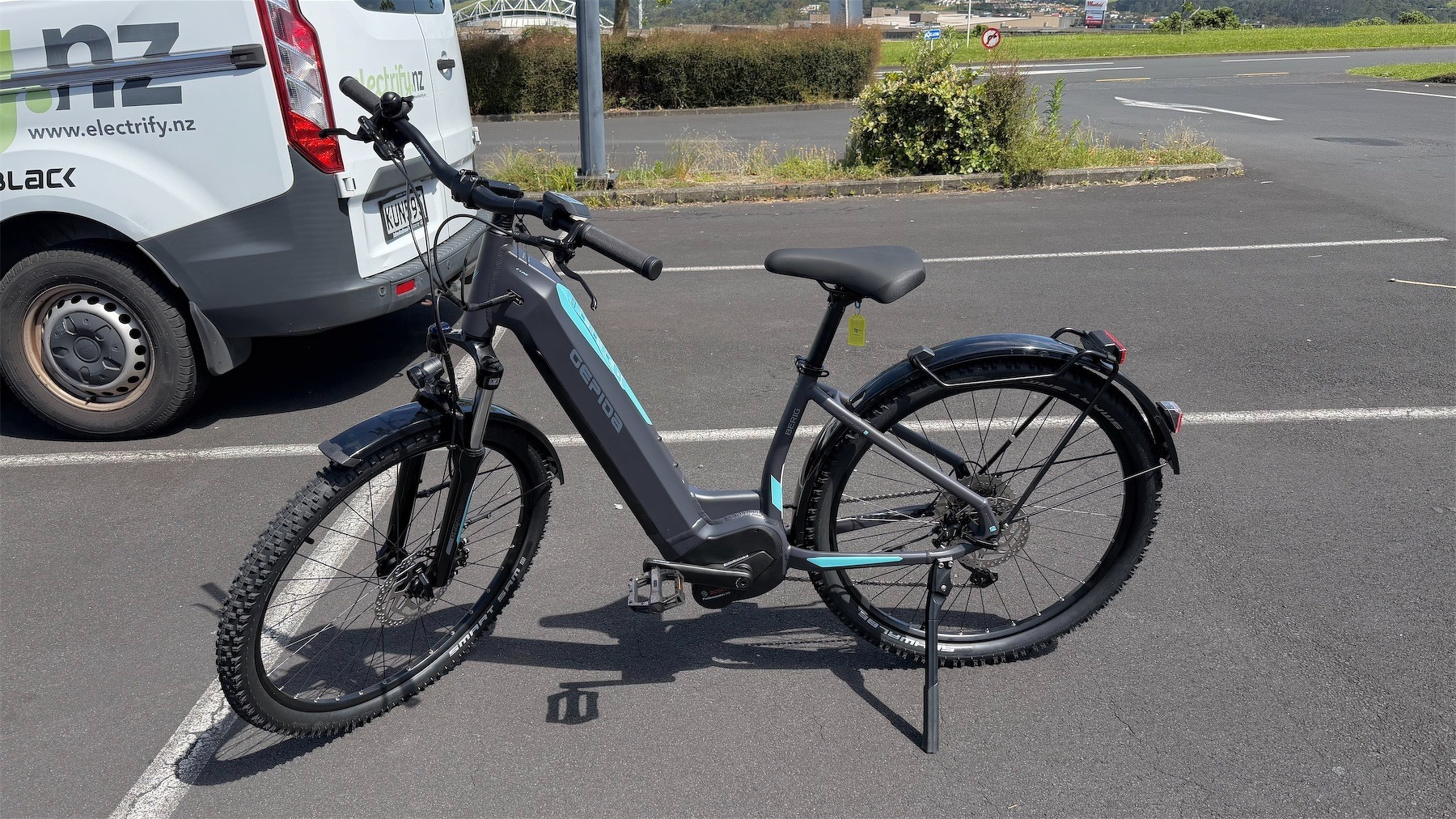 Gravel bike on a kickstand in a parking lot. 
