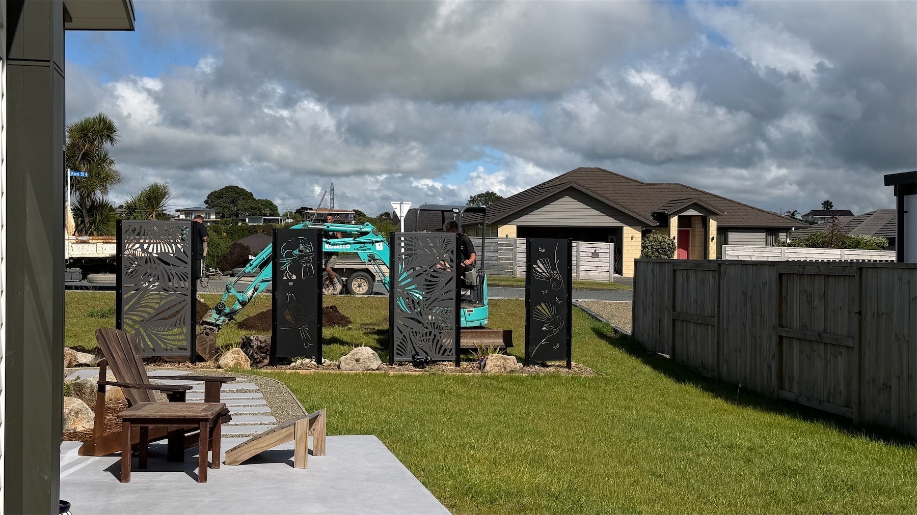 Digger visible behind privacy panels.