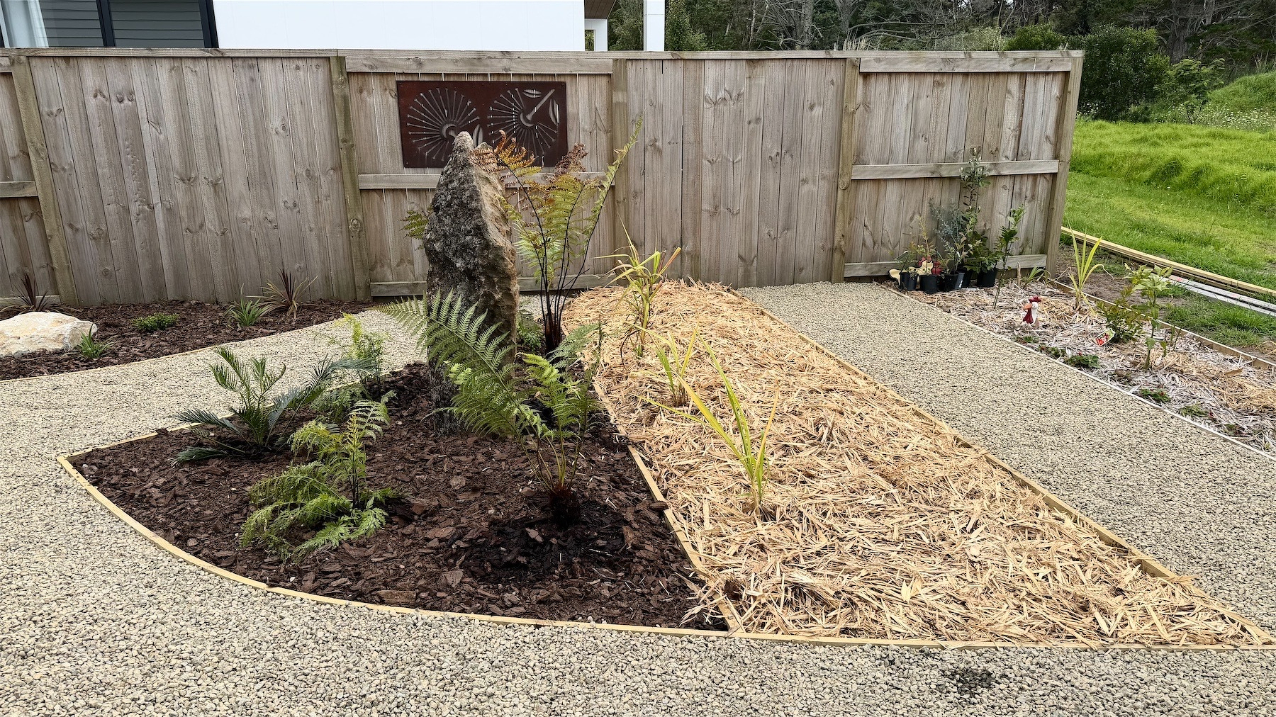 We specially love the big rock and fernery. Mulch covers our new vege patch.