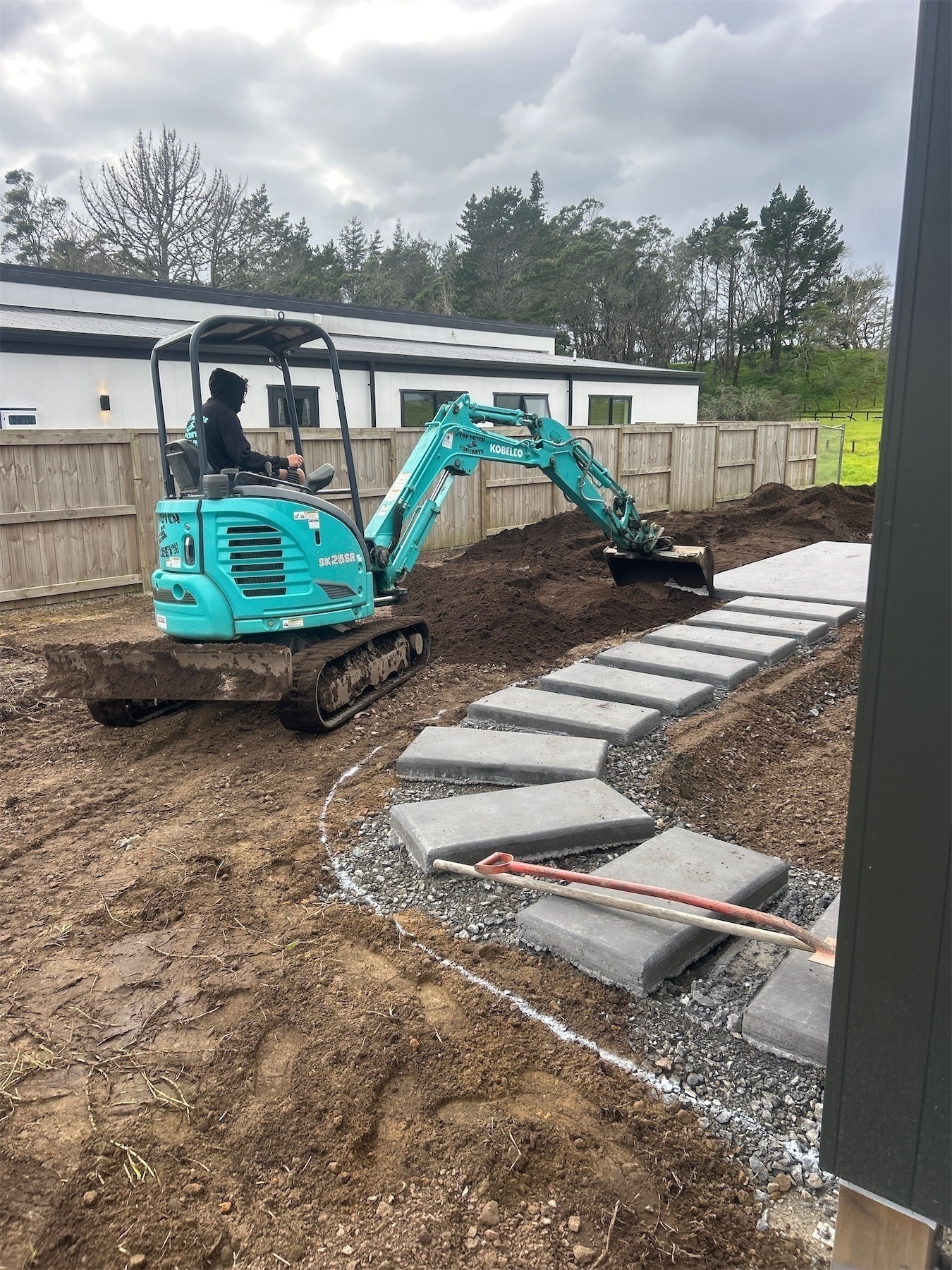 Fresh topsoil being aplied by digger.