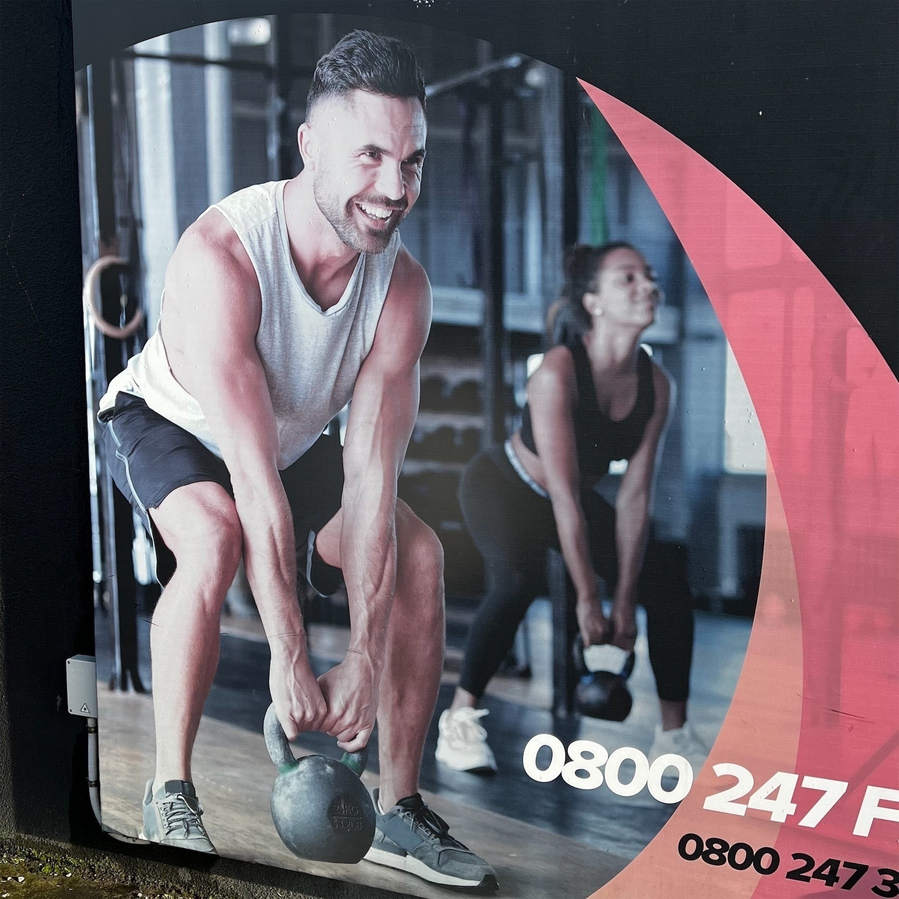 Poster shows smiling people lifting weights.