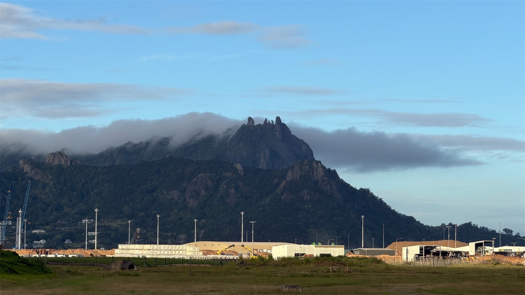 Distant shot of a craggy mountain with dark cloud around the summit.