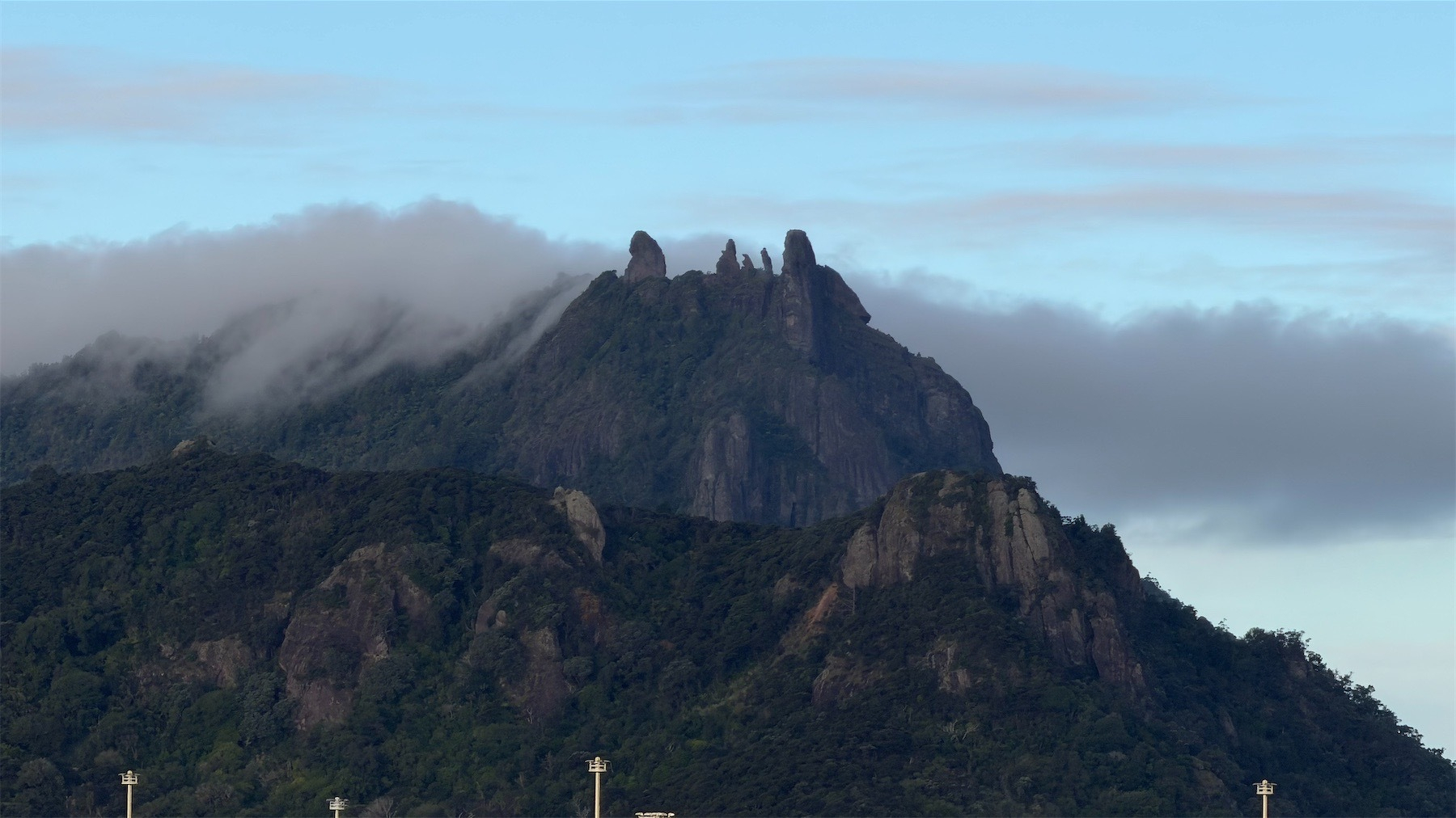 Close up shot of a craggy mountain with dark cloud around the summit.