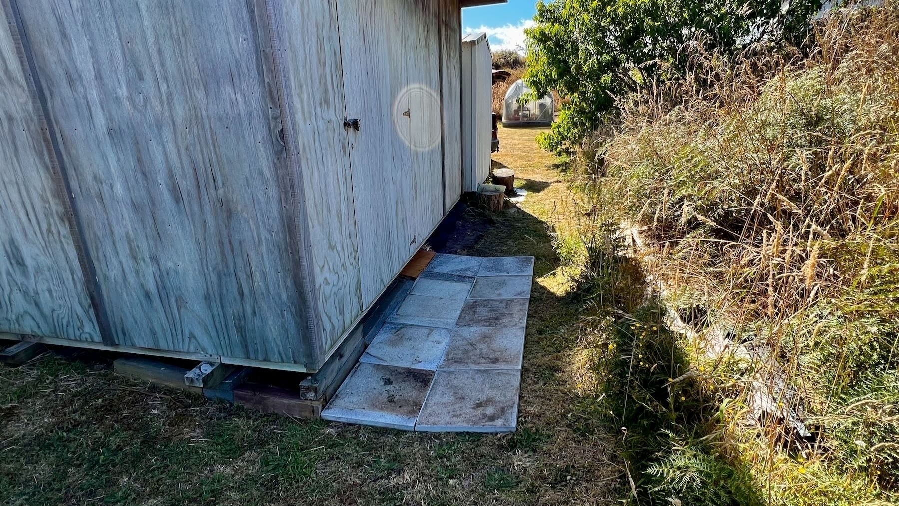 10 Pavers placed in front of shed.