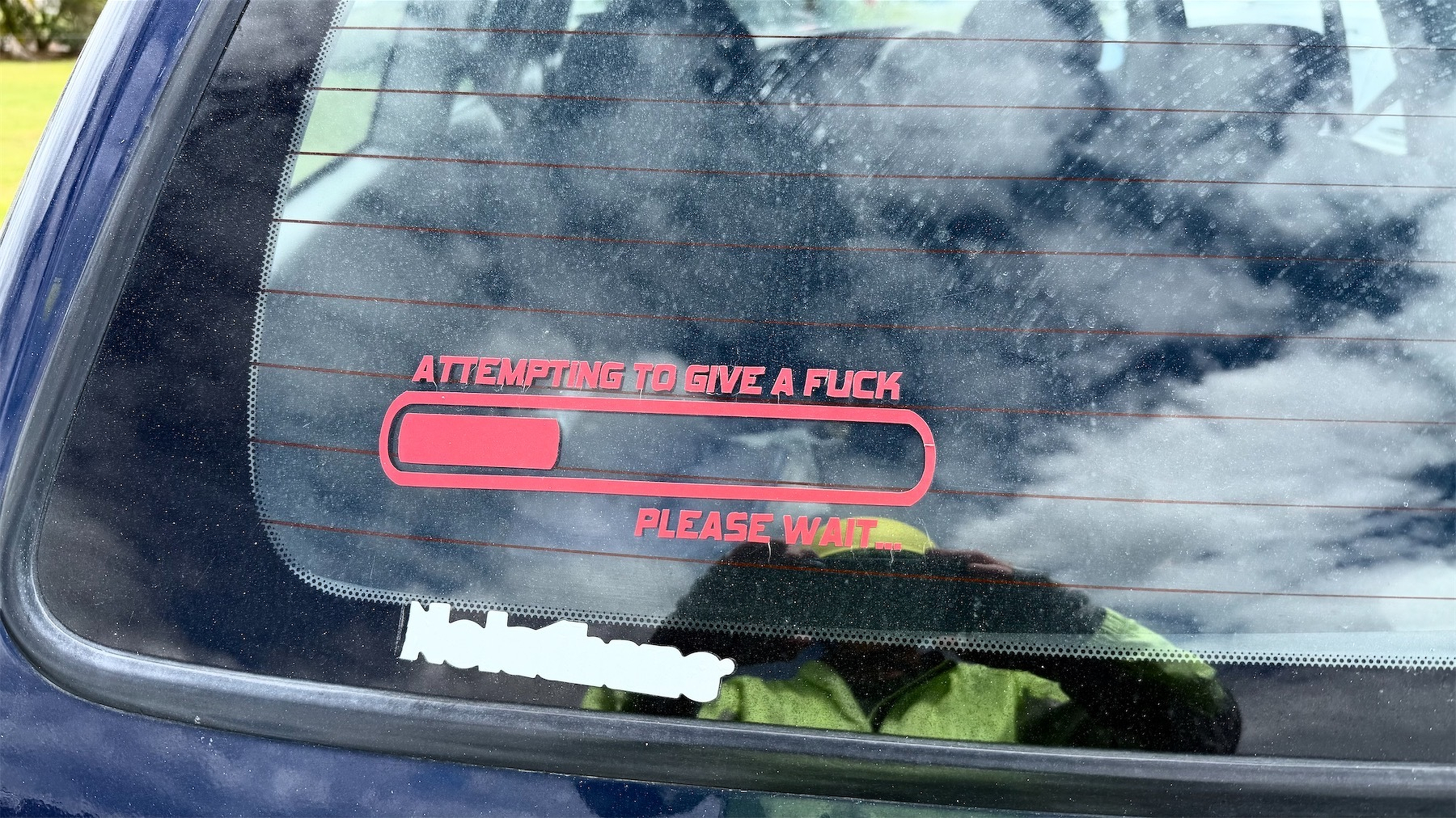 Car sticker resembles an almost fully discharged battery progress bar. The text reads: Attempting to give a fuck. Please wait.