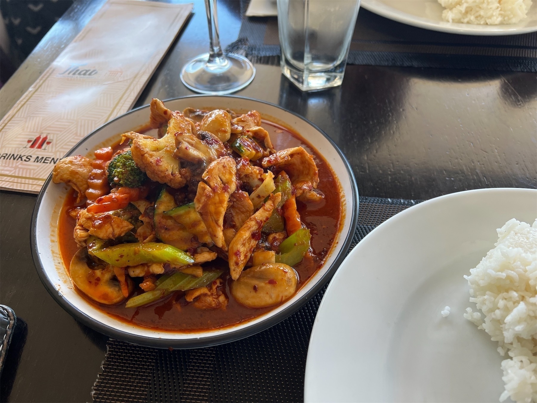 Dish with chicken and vegetables in sauce.