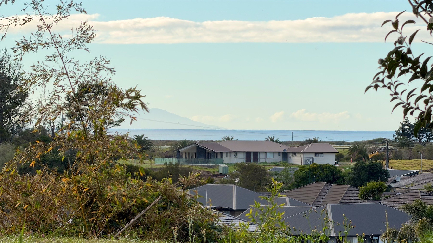 View across roofs to the sea.