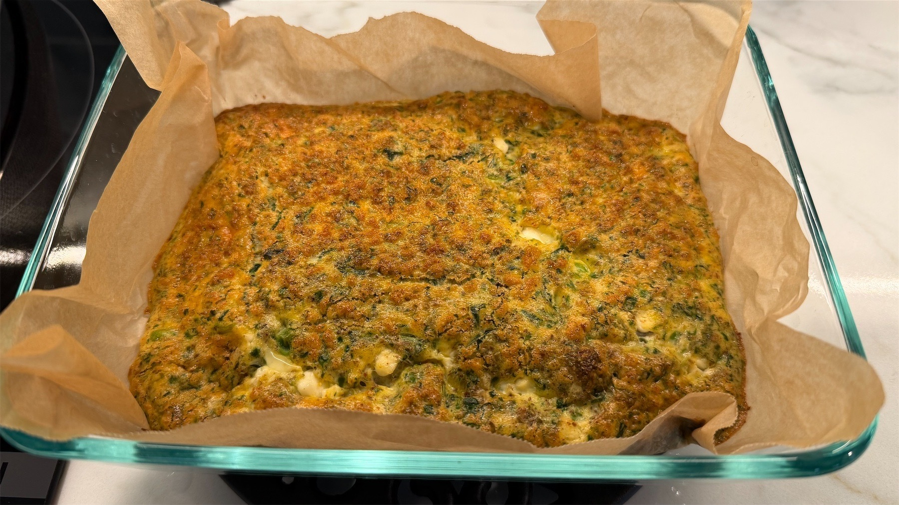 Cooked frittata in a baking dish.