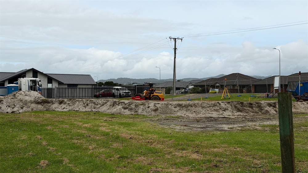 A roller compacting solid at a building site. 