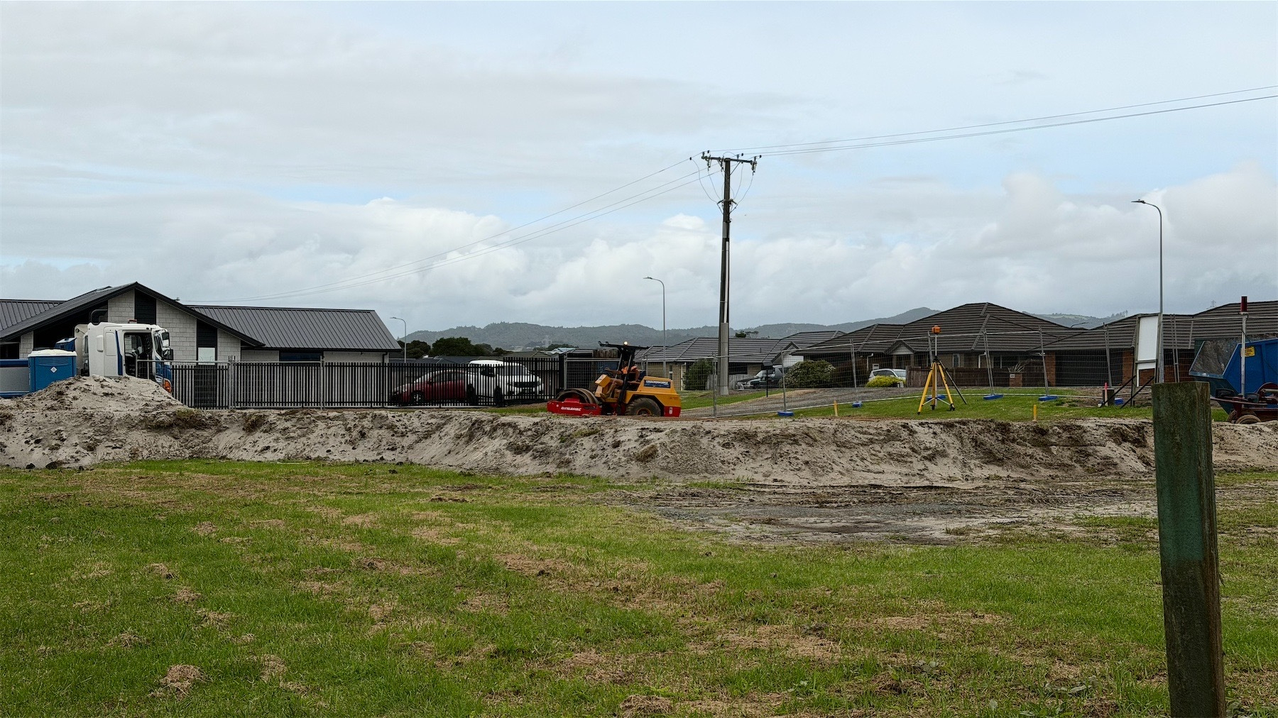 A roller compacting solid at a building site.