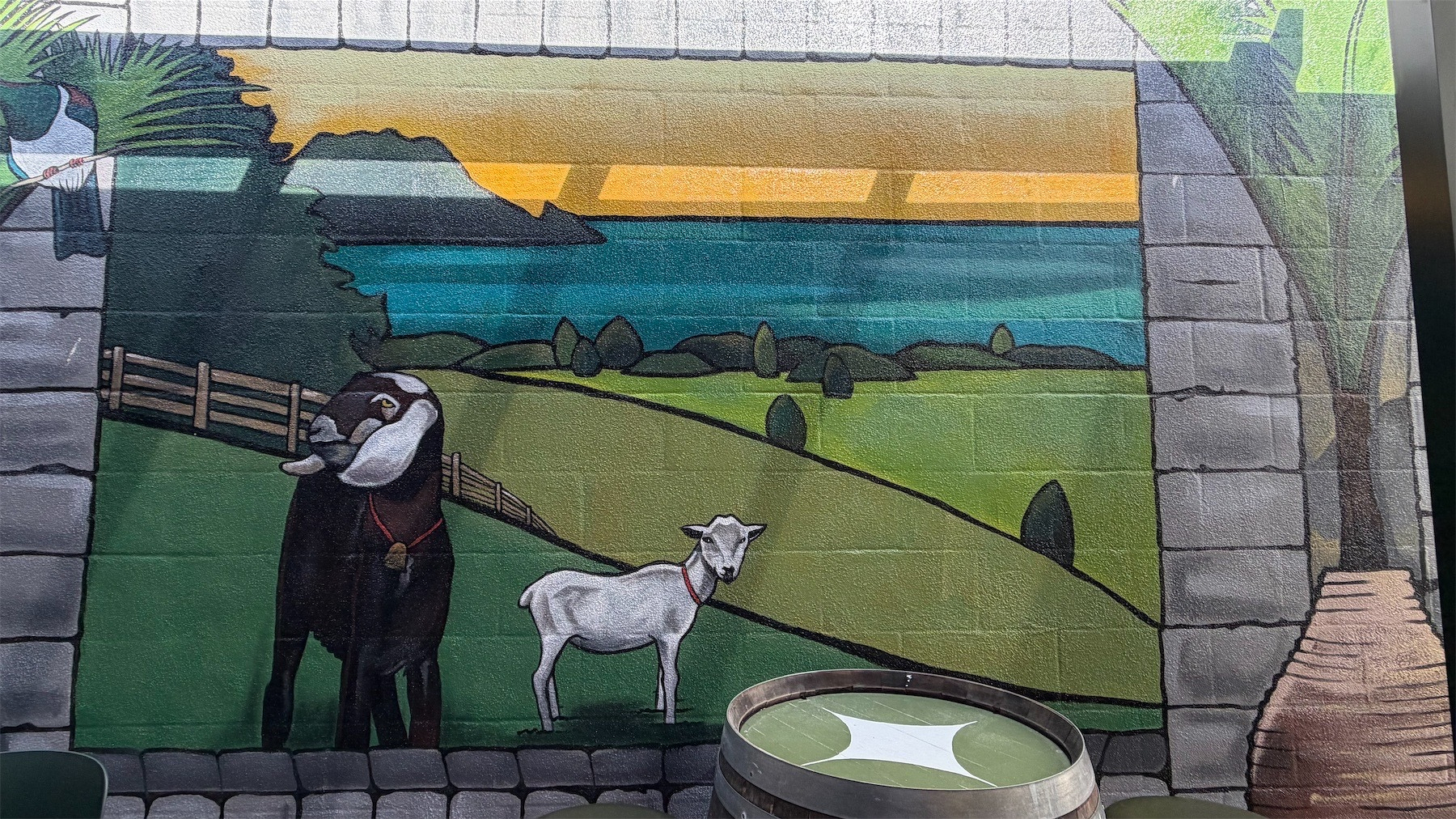 Colourful mural featuring goats in paddocks. 