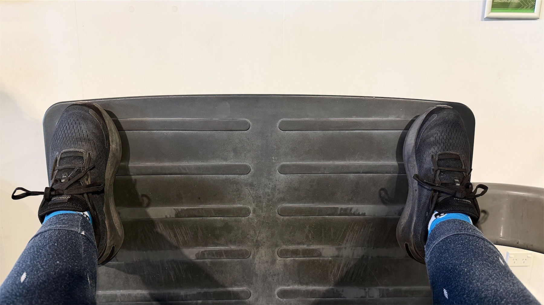 Feet wide apart on the foot pad of the horizontal leg press machine.