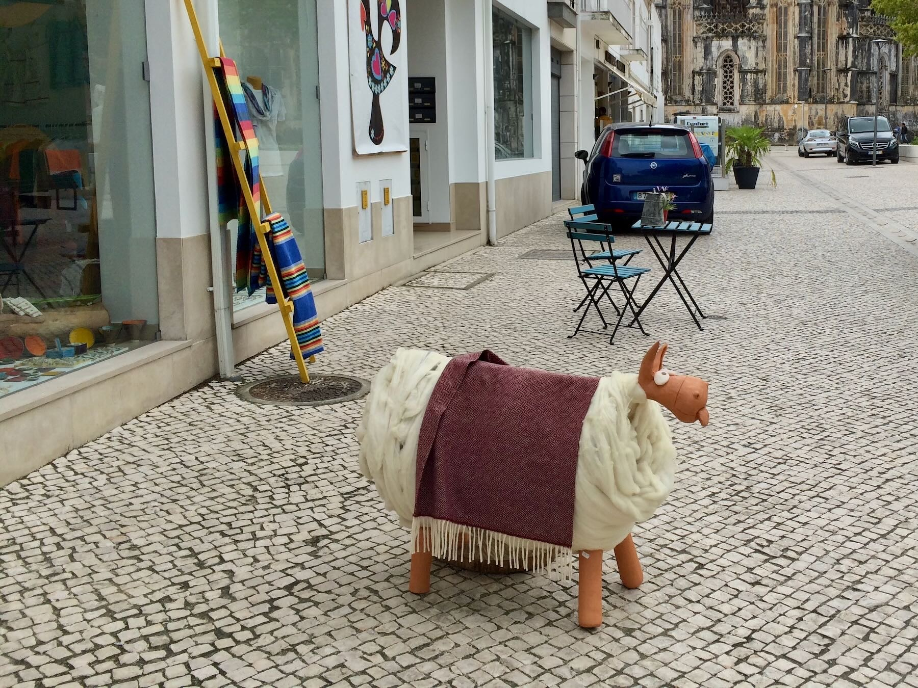 Wooden sheep covered in white and brown wool In Batalha, Portugal.
