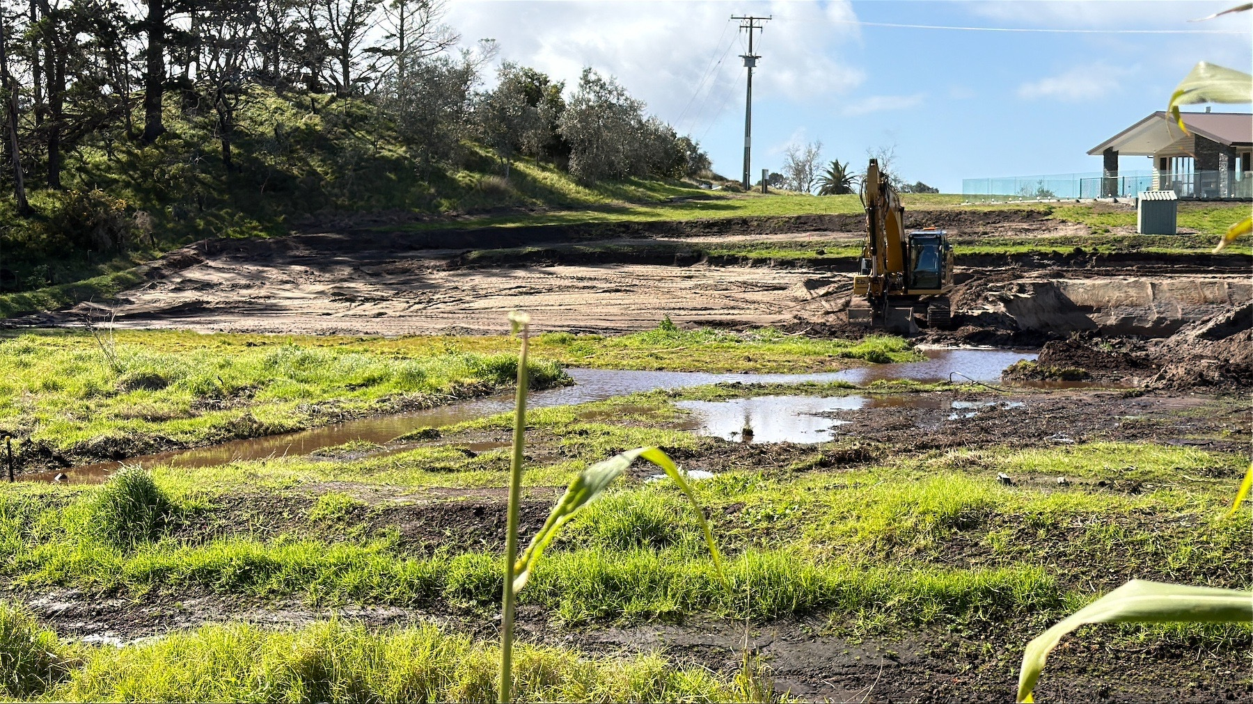 Boggy ground, partially excavated and with a lot of standing water. 