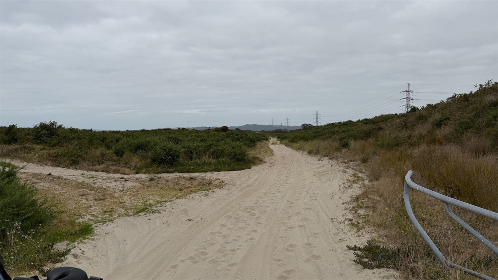 A sandy track with deep ruts from motor vehicles.
