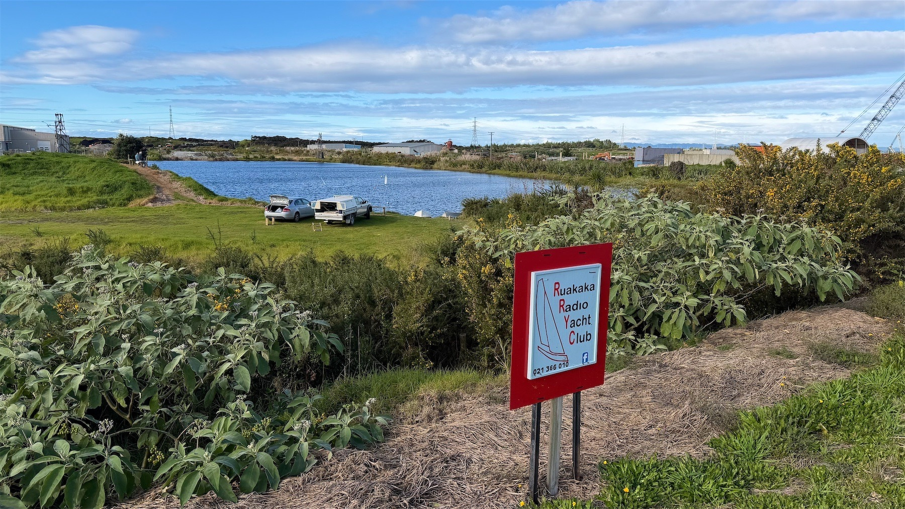 Sign by lake says Ruakaka Radio Yacht Club.