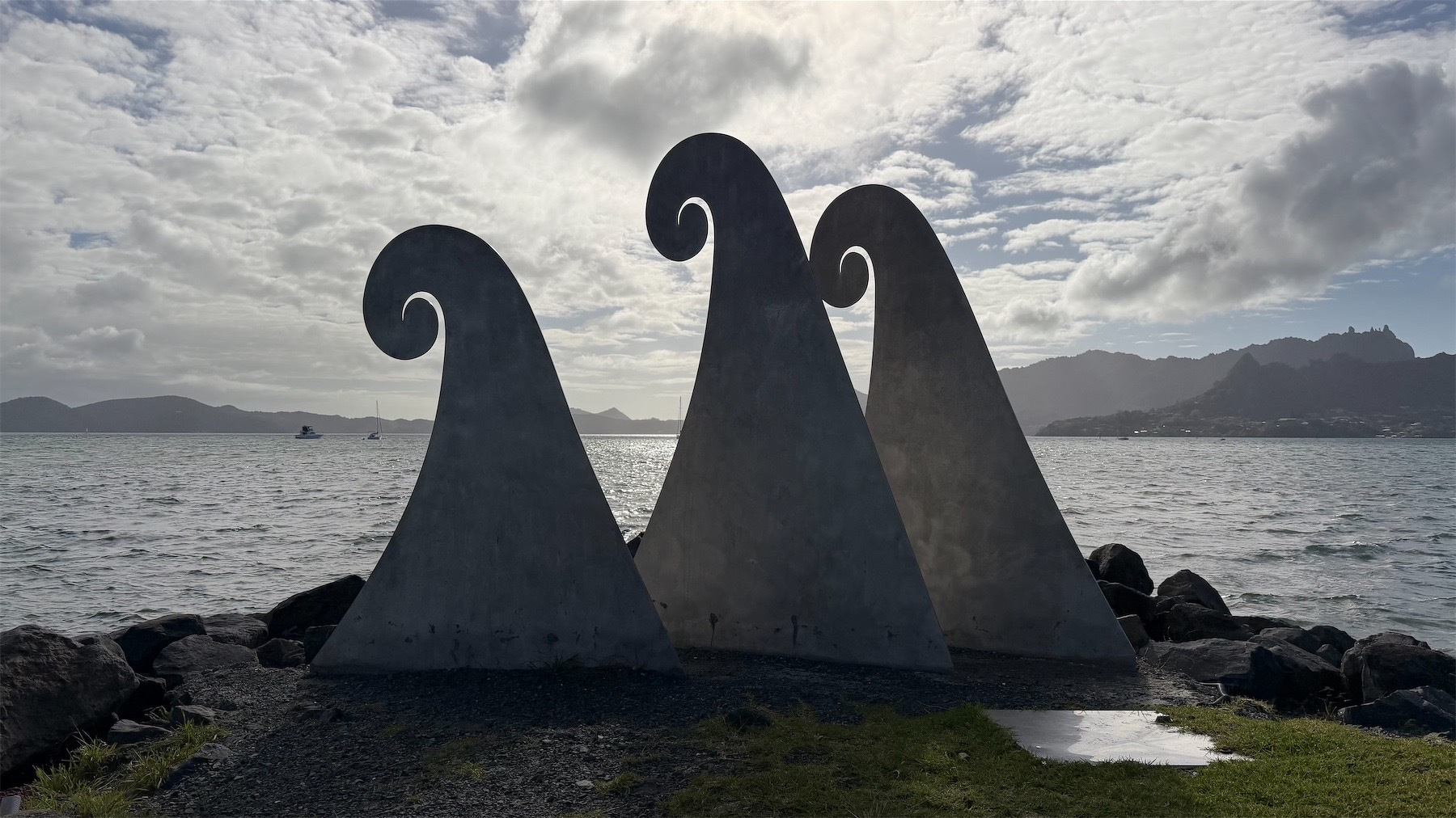 Sculptures at the canal entrance - in silhouette and closeup.