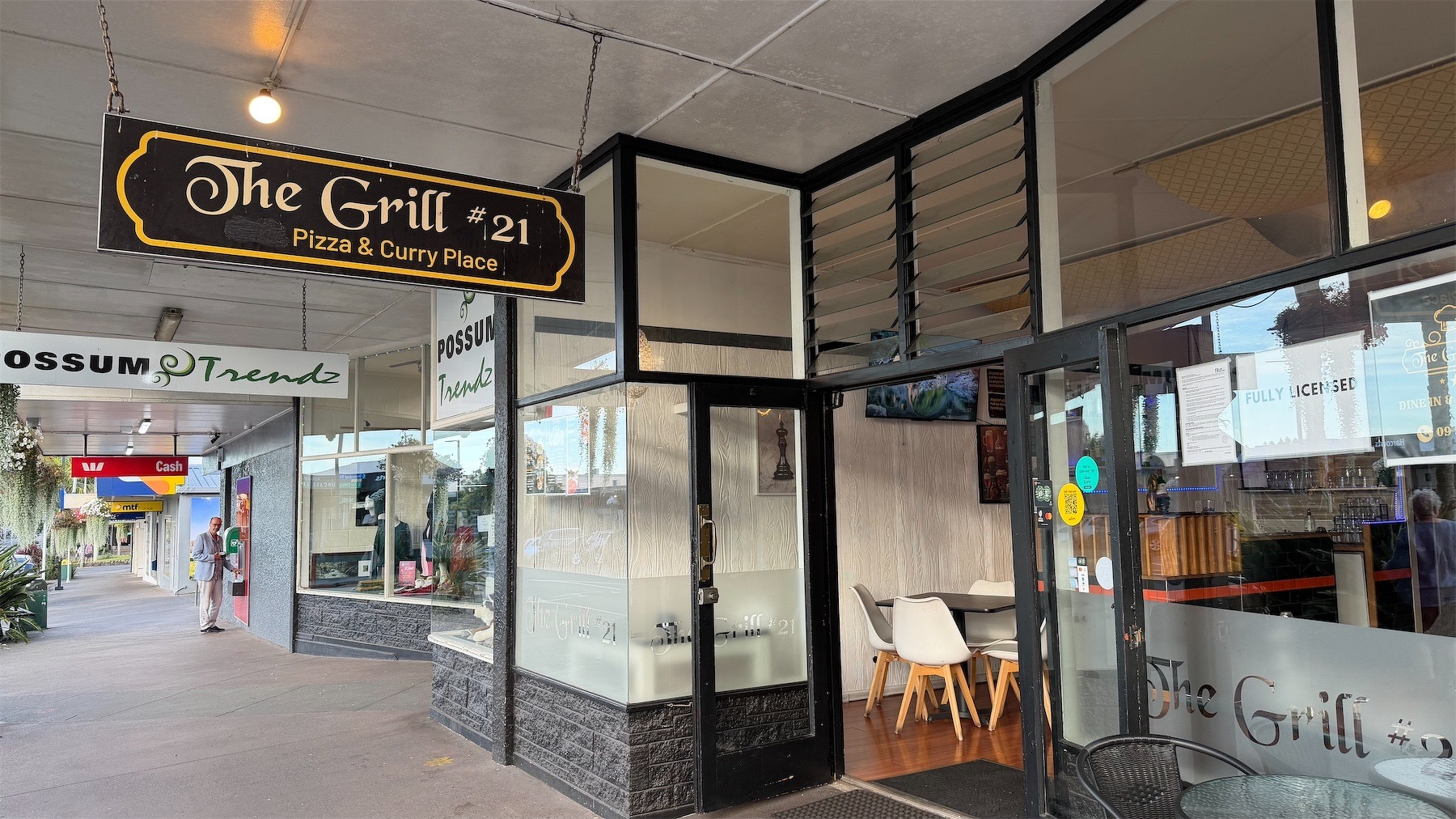 Exterior of The Grill, with sign.