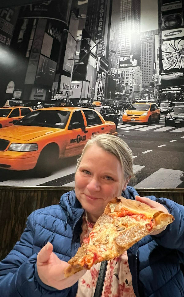 Jody with a slice of pizza