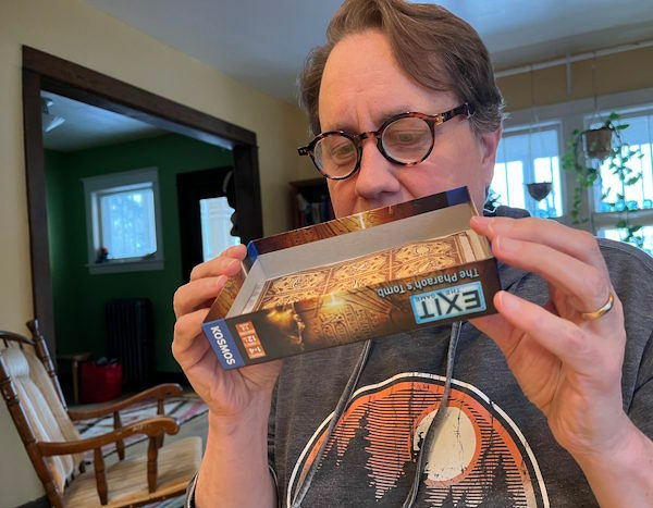 Justin reading boxed Escape Room cover