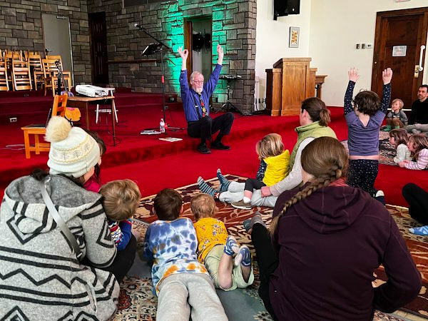 Phil telling a story to a group of children