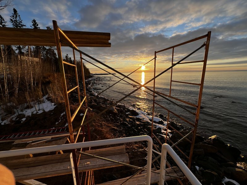 Sunset through scaffolding on the lake