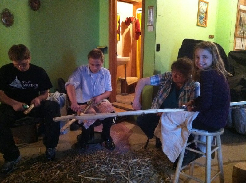 Grandma teaching the kids to whittle