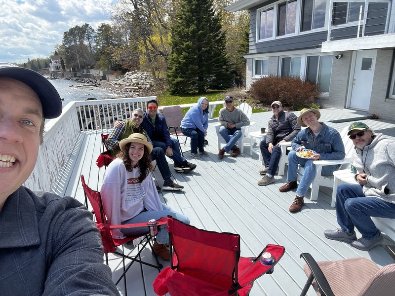 Friends gathered on the lakeside deck