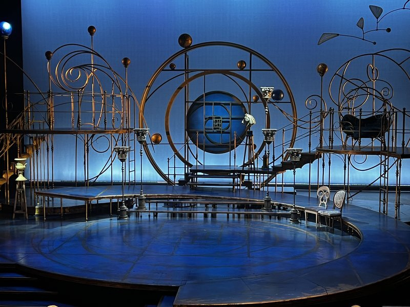 The set for A Midsummer Night's Dream, a blue-lit tangle of rings and orbiting spheres