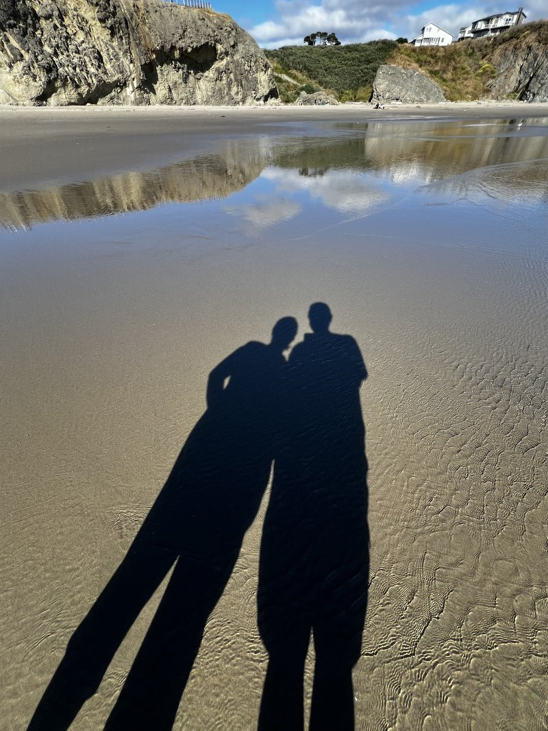 Justin and Jody's shadows stretched across the wet sand