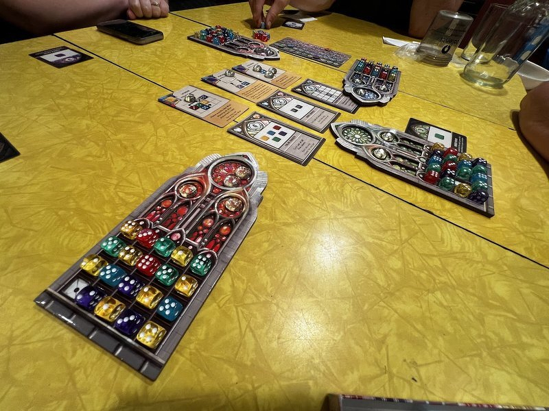Finished stained-glass window boards full of colored dice at the end of a game of Sagrada