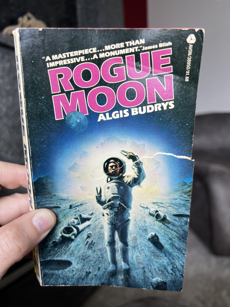 A battered Avon paperback of Rogue Moon by Algis Budrys