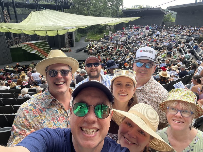 A group selfie in the Hill Theatre seats, the amphitheater filling up behind us
