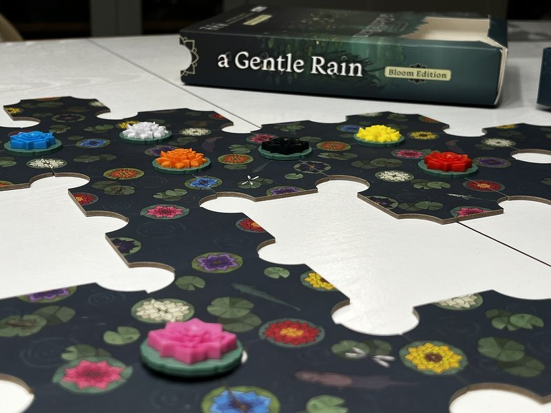 The A Gentle Rain board mid-game, colorful blossoms scattered across the dark puzzle tiles