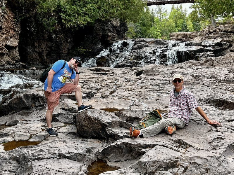 Robert and John down on the exposed riverbed rock that is normally under water