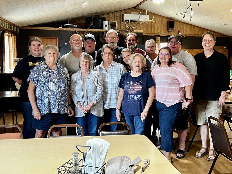 The extended family lined up together for a group photo at the birthday party