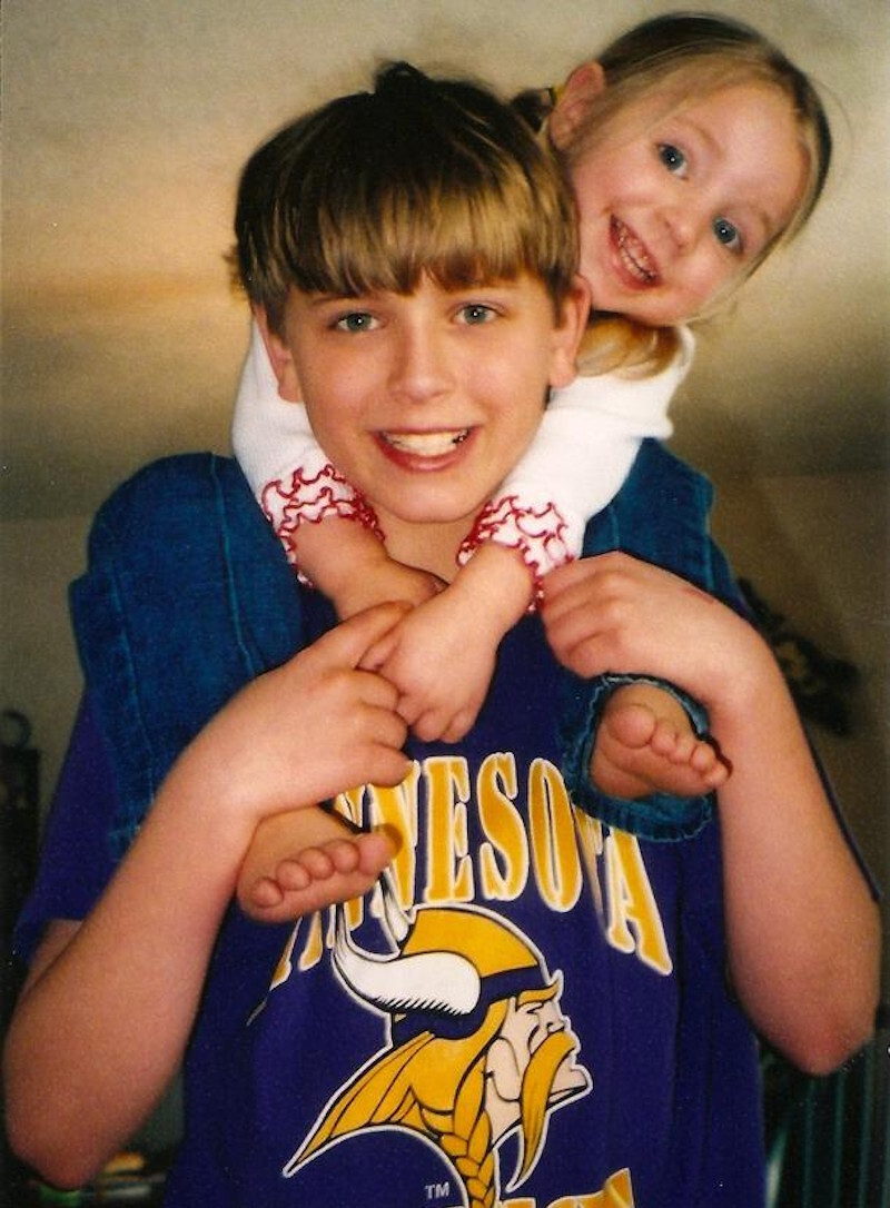 A teenage Alex carrying a little Kaylee on his shoulders