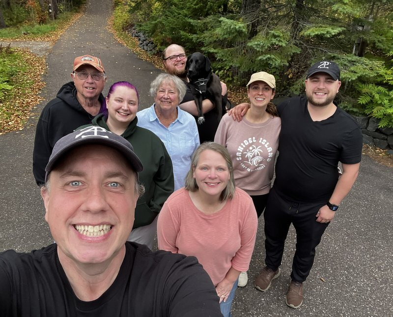 Our family in our driveway, fall colors all around