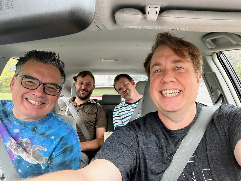 A car selfie of Jeff, Daniel, Robert, and me setting out on the road trip