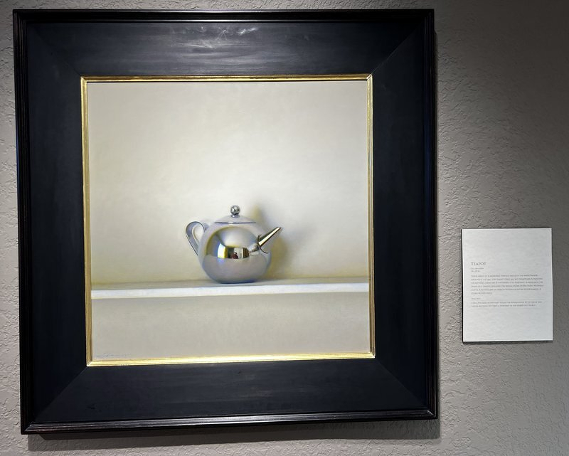 A Jeffrey Larson still life of a single silver teapot on a pale shelf, in a heavy black frame